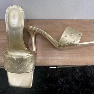 Metallic gold woven heeled sandal/mule by Marc Fisher